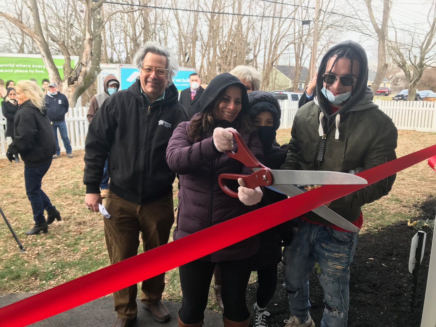 Mariela Calderon cuts the ribbon to her new home on Provost Avenue in Bellport.